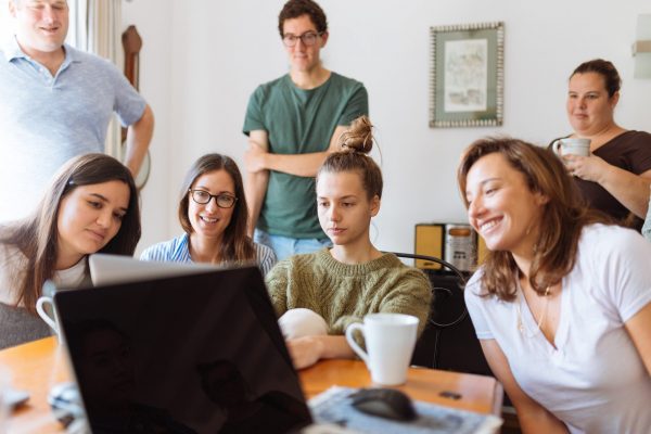 Family Laughing Around Laptop