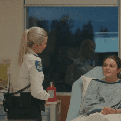 Healthcare security guard checking on a patient
